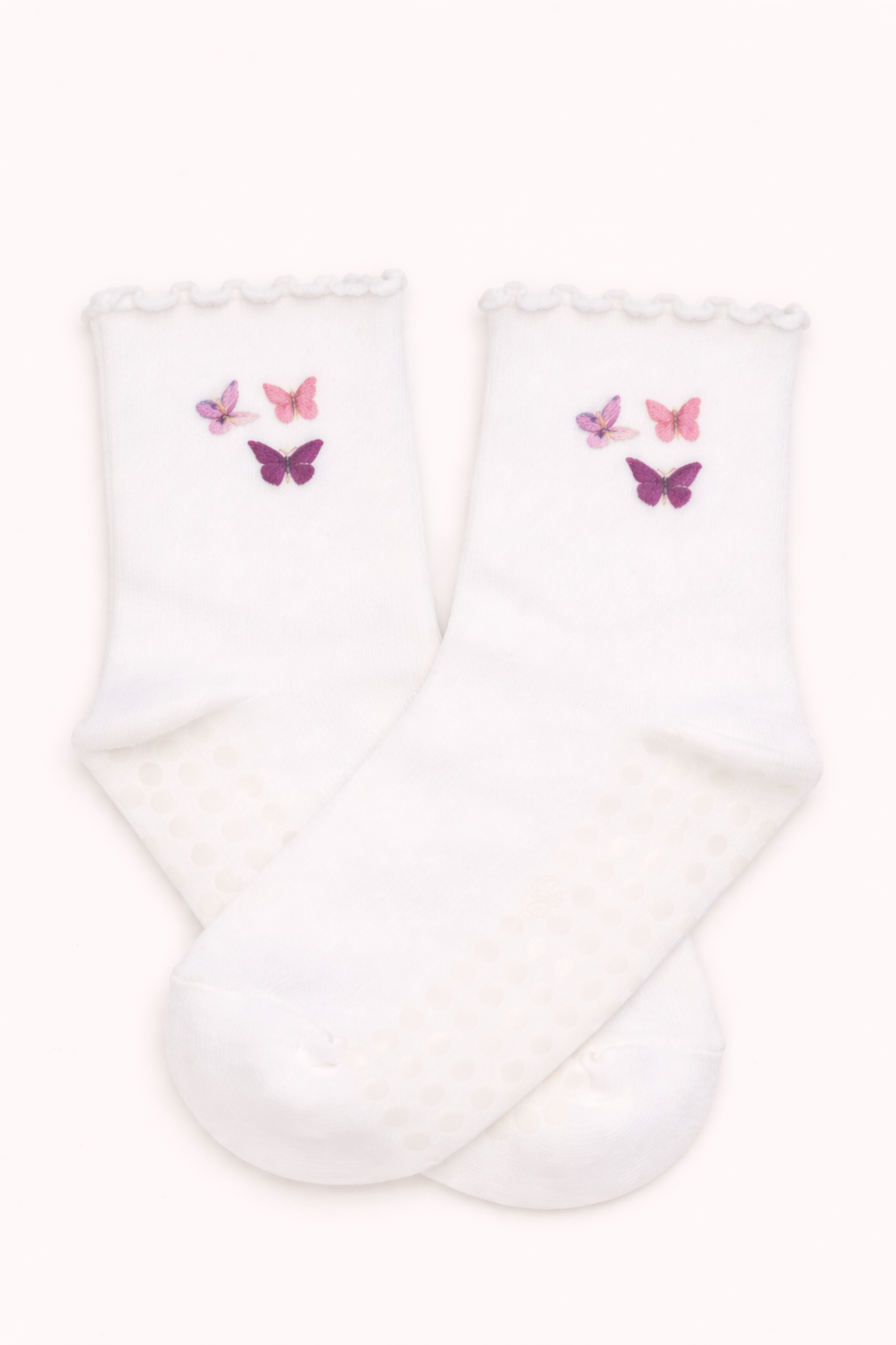 White embroidered butterfly Pilates grip socks featuring pink and purple butterfly designs, non-slip soles, ruffled ankle detail, and breathable fabric, ideal for Pilates, barre, yoga, and studio workouts.