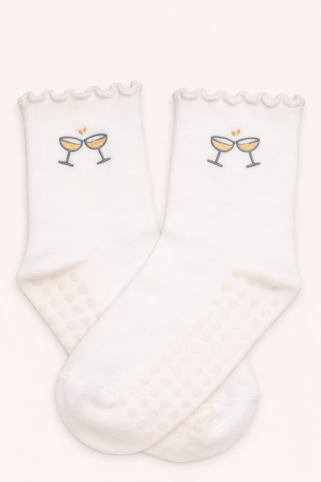 White embroidered champagne glass Pilates grip socks featuring non-slip soles, ruffled ankle detail, and breathable fabric, ideal for Pilates, barre, yoga, studio workouts, and stylish athleisure wear.
